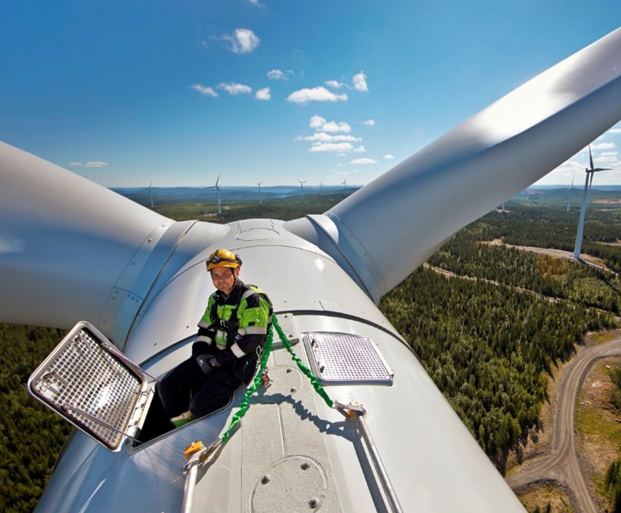 Man on the top of a wind turbine