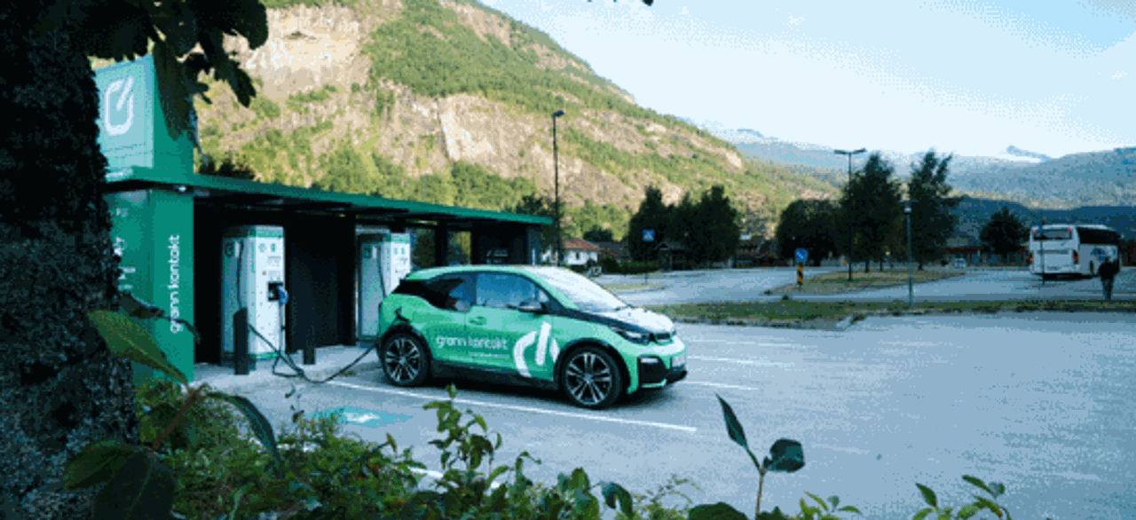 Green car at charging station