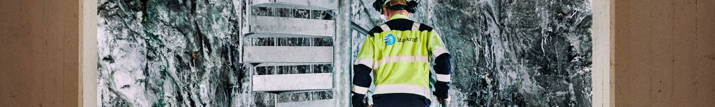 Statkraft employee walking up stairs in hydropower plant