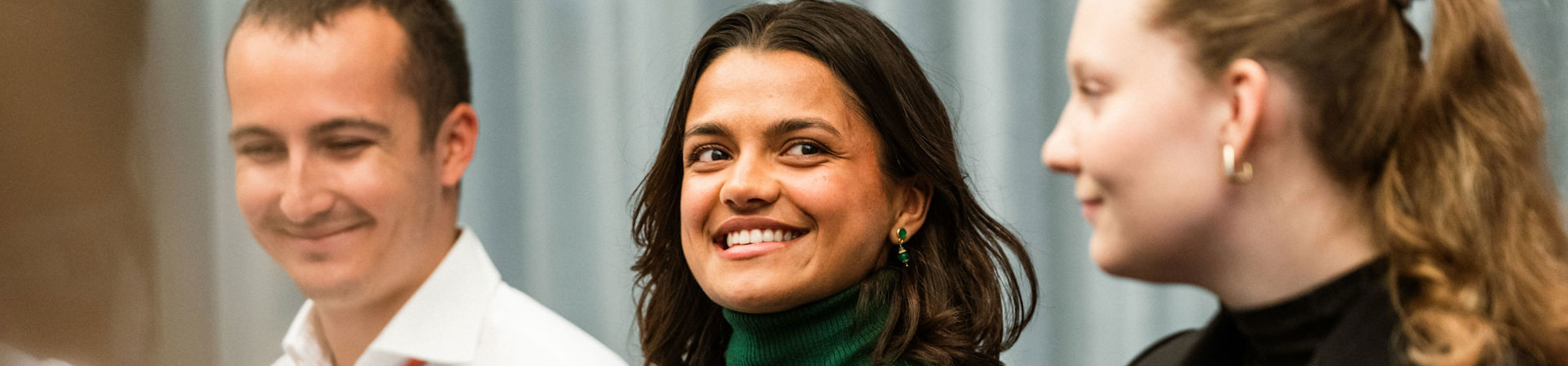 Female and male employees smiling