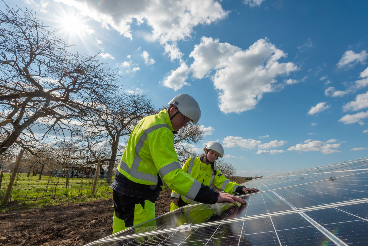 people inspecting solar panel