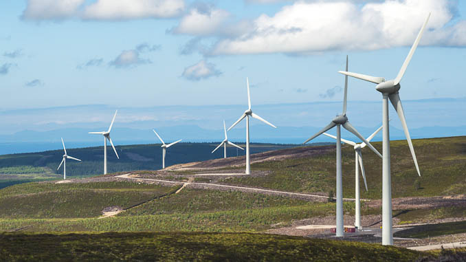 View of operational wind farm on hill