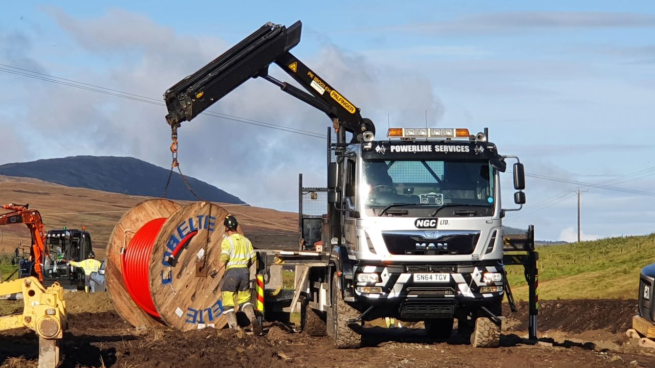 Picture of a white construction van outside at a windfarm