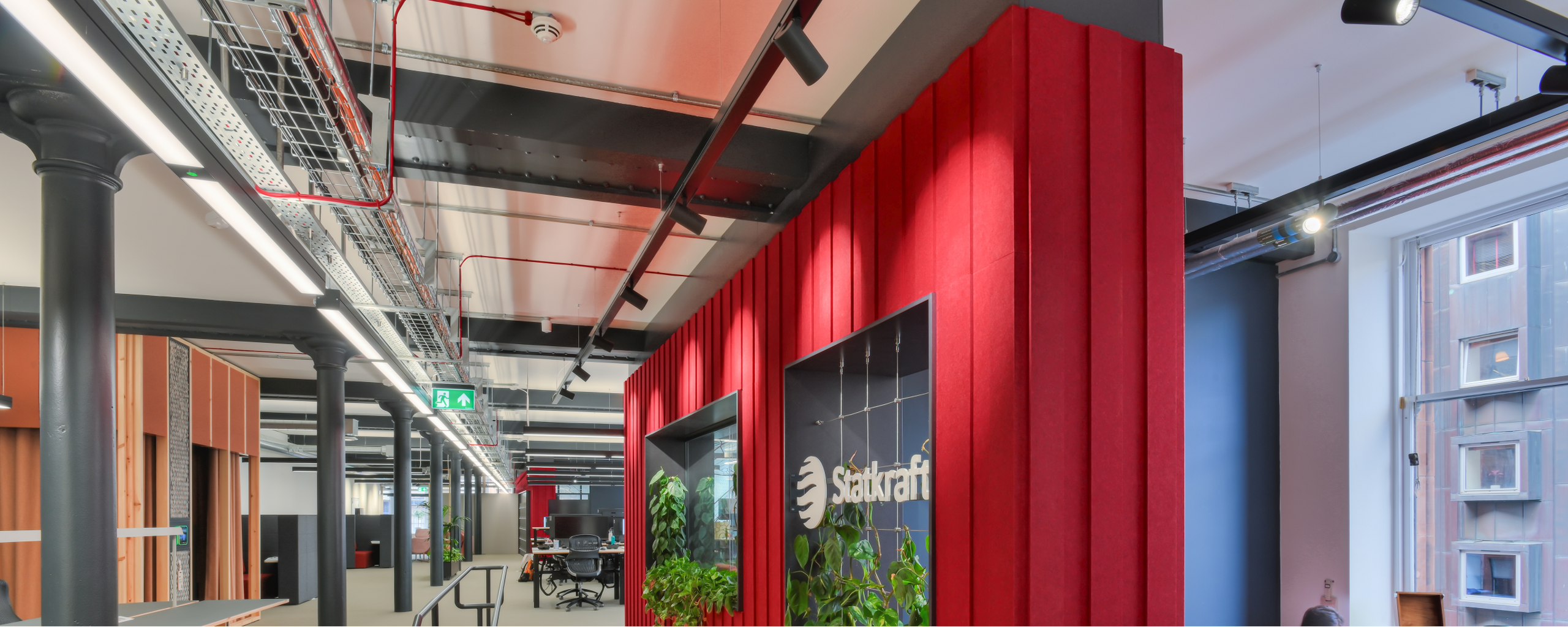 Office space with tables, chairs and green plants