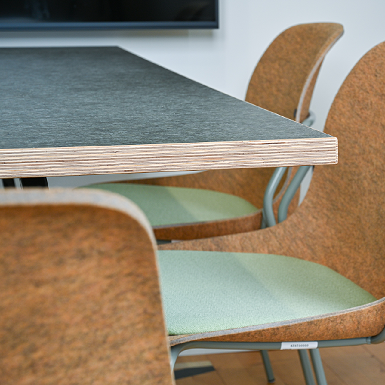 Dark grey kitchen table top with green chairs